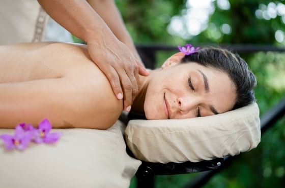A girl enjoying a massage in the spa at Rio Celeste