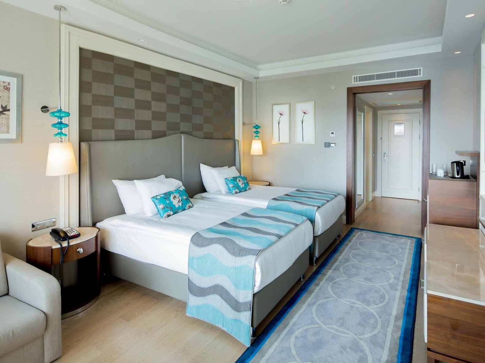 Sitting area & nightstand by the bed in Standard Room at Titanic Deluxe Golf Belek