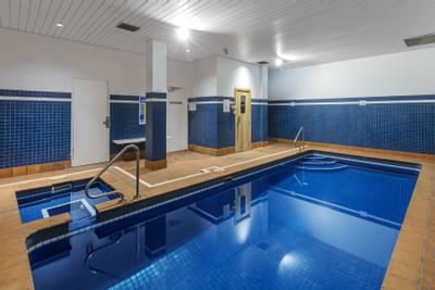 An indoor pool with baby pool at  Nesuto Hotels