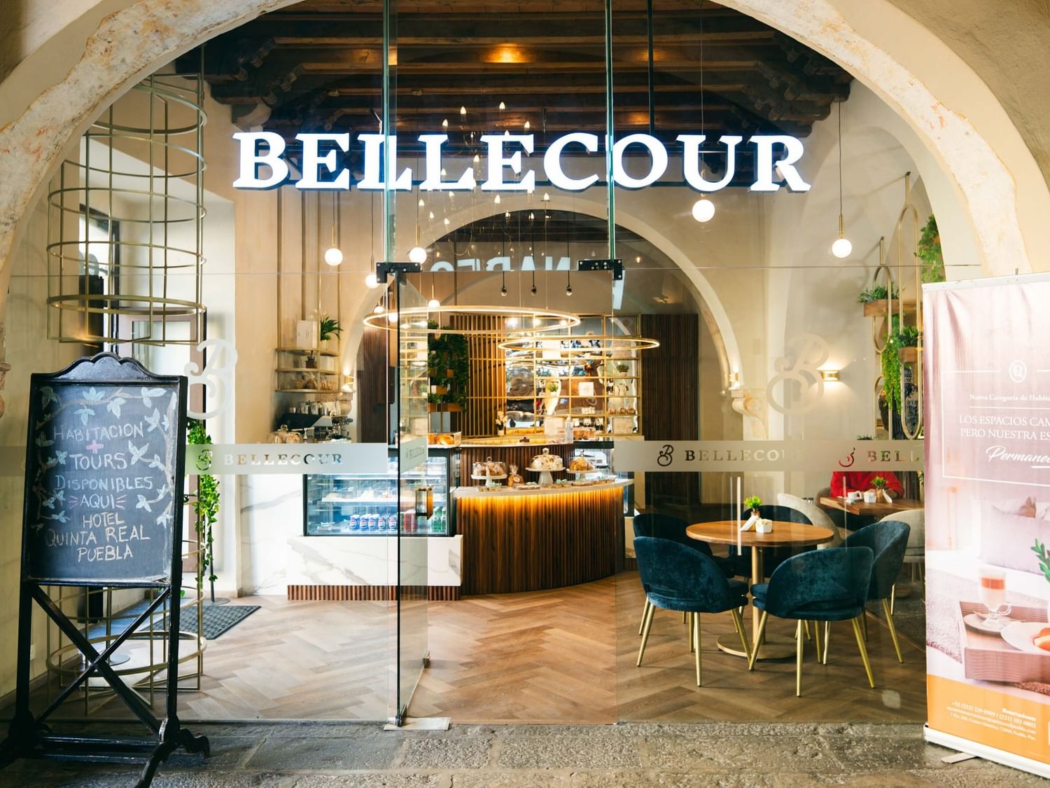 Bellecour Bakery & Coffee entrance showcasing interior seating and decor at Quinta Real Puebla in Heroica Puebla de Zaragoza.