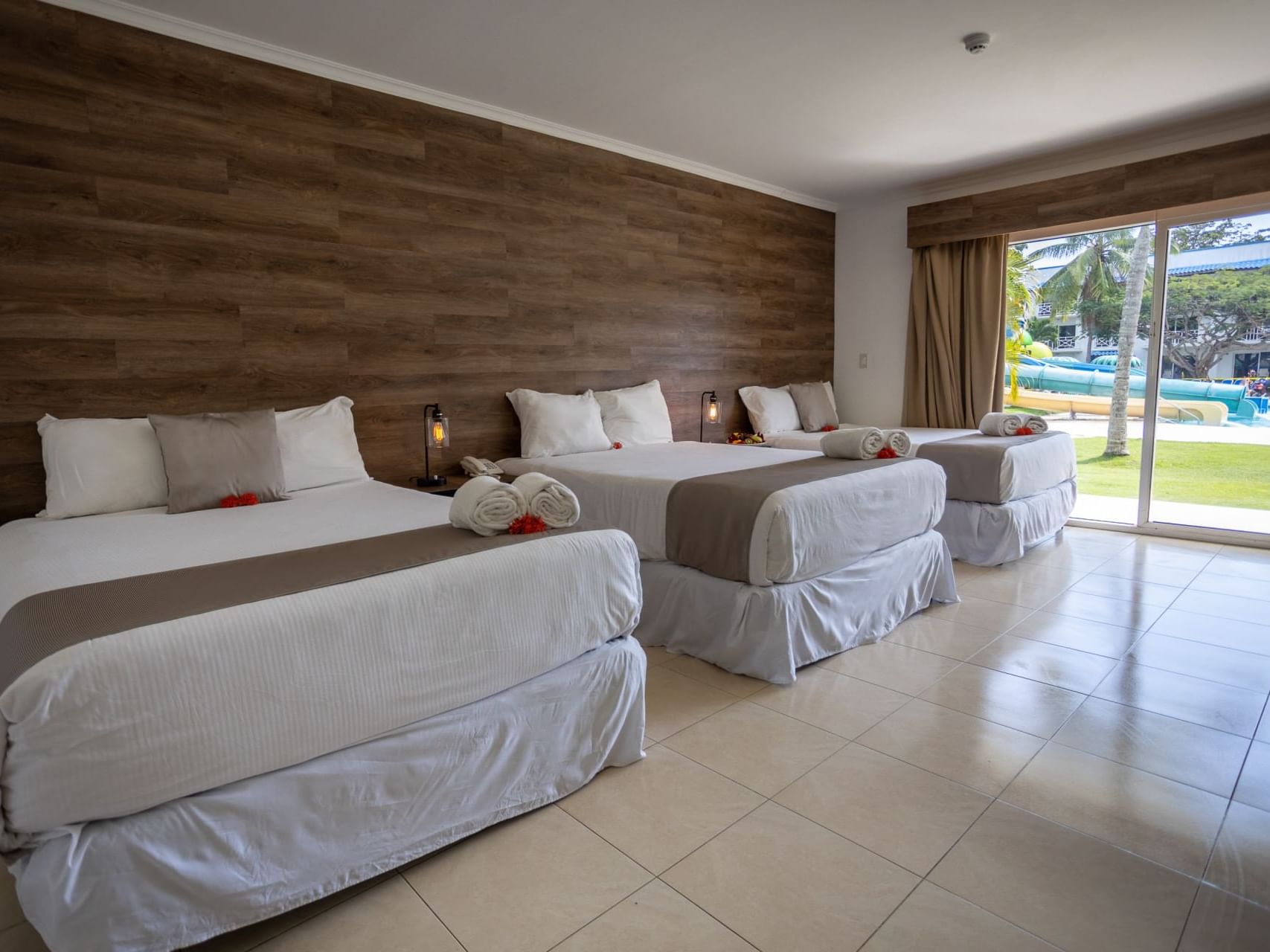 Family Room with 3 double beds and sliding doors to outdoor area at Playa Blanca Beach Resort