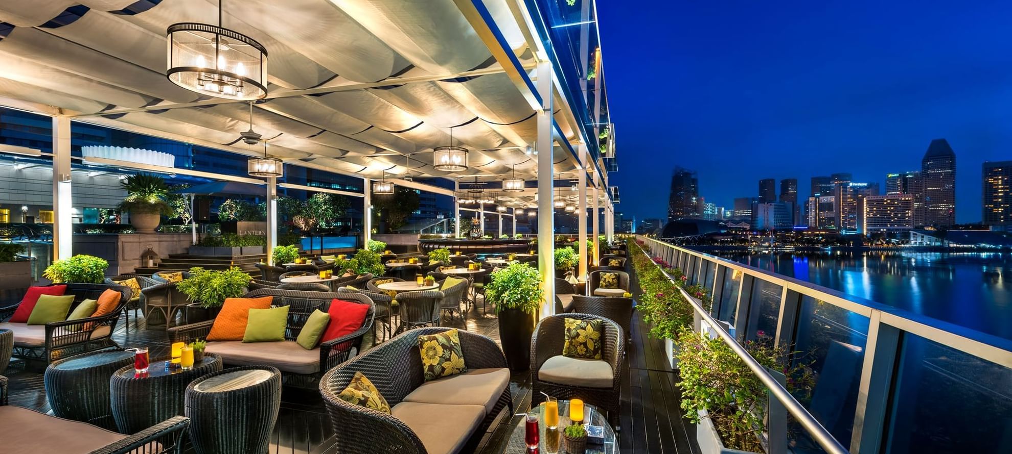 Outdoor dinning area with comfy chair and tables in Lantern restaurant at The Fullerton Bay Singapore