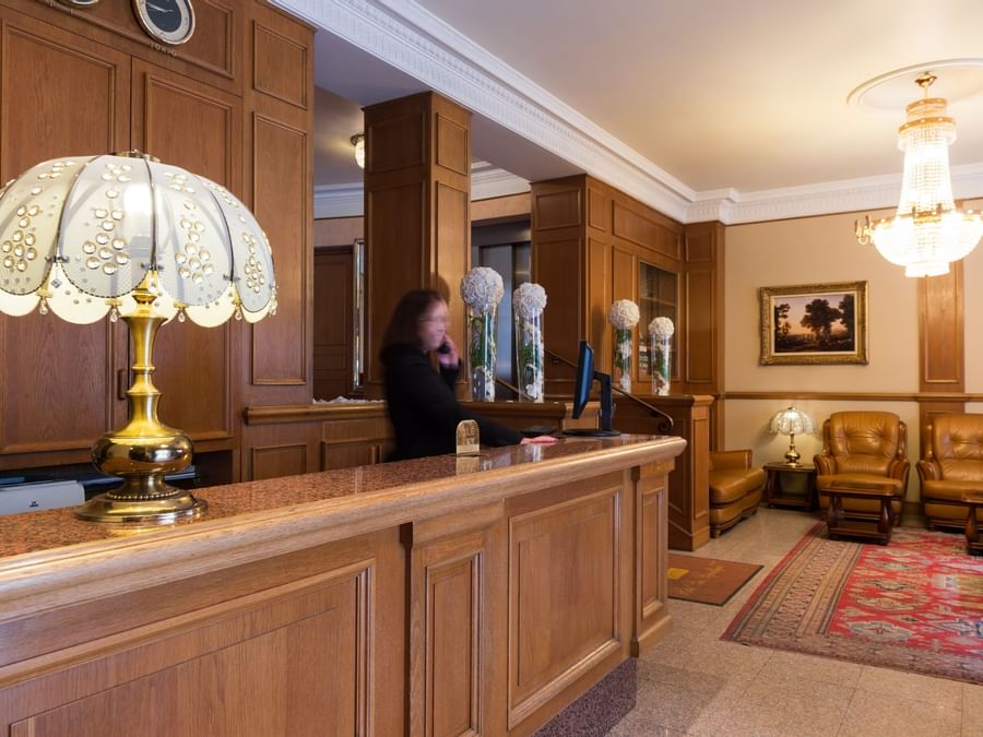 A receptionist at the reception desk in Hotel Paix Republique