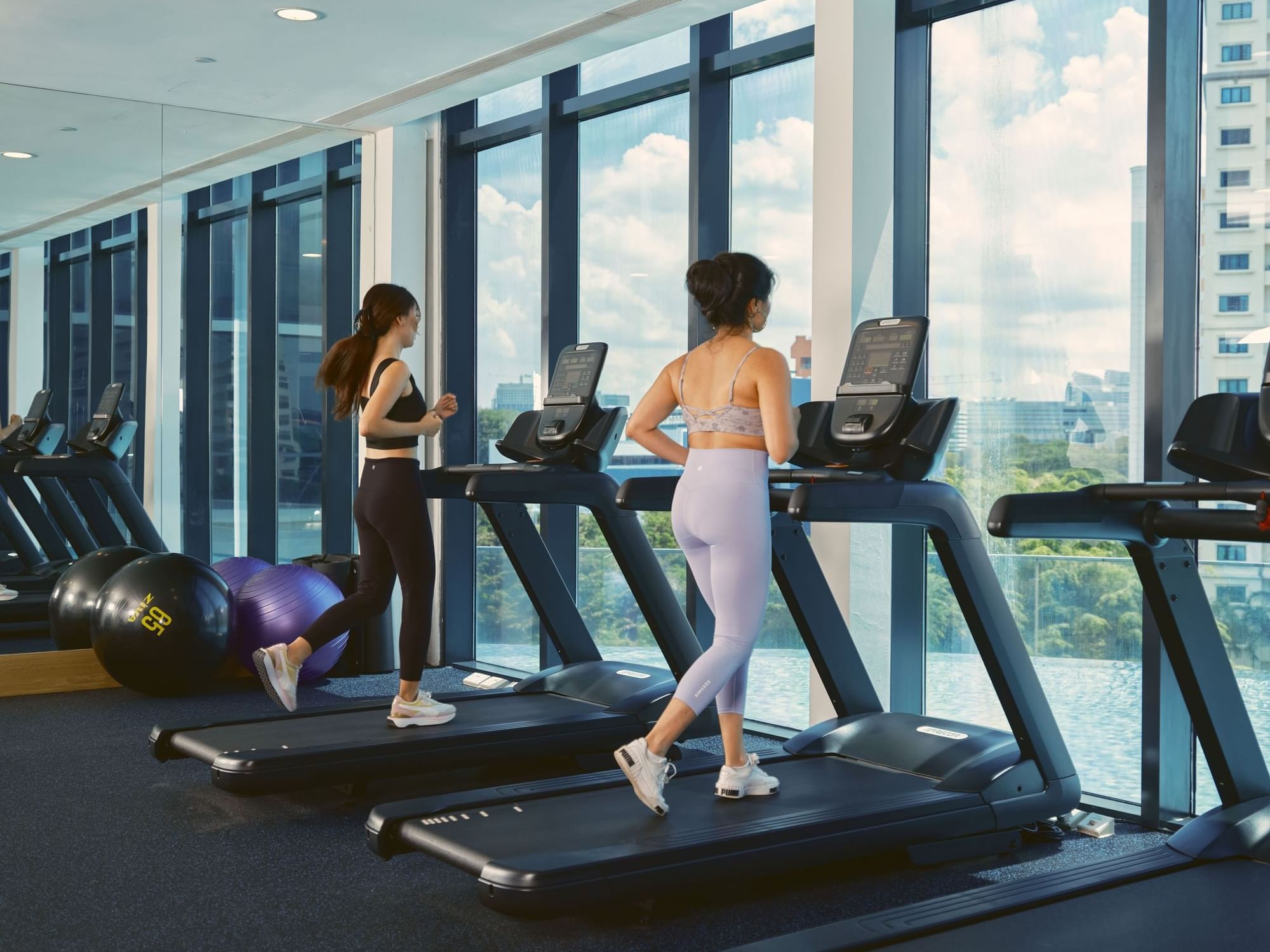 Two women running on treadmills in Gymnasium at Momentus Hotel Alexandra