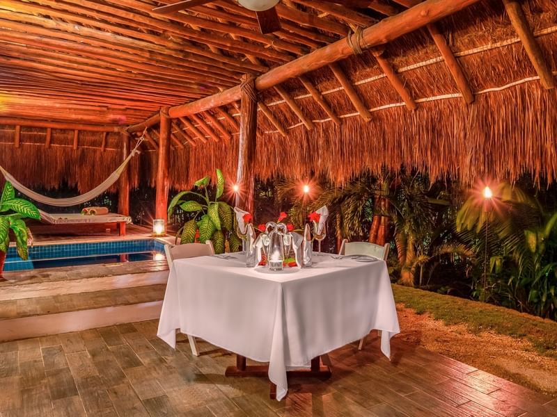Romantic dining table arranged in a cabana at night in The Explorean Kohunlich