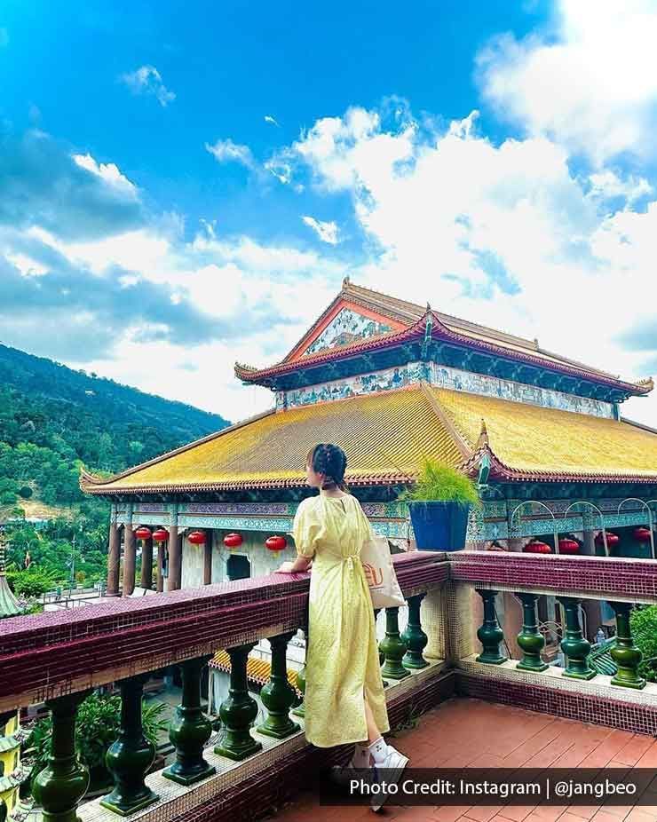 A woman styled in a yellow dress at Kek Lok Si temple - Lexis Suites Penang