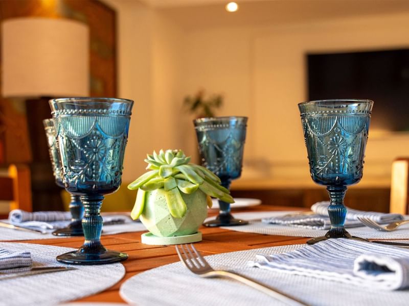 Dining table set with blue glassware in the Grand Club Lounge at Grand Fiesta Americana