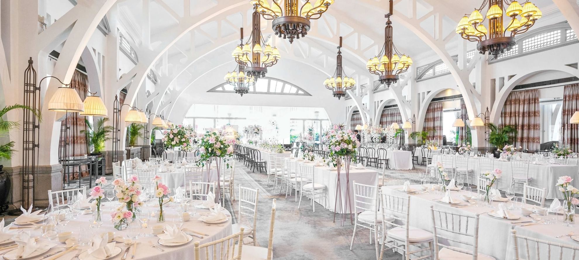 Wedding hall with dinning tables and chair arranged for an event at The Fullerton Bay Singapore