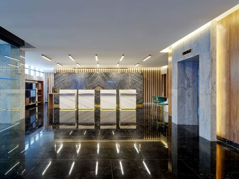 Reception area with elevators at La Colección Resorts
