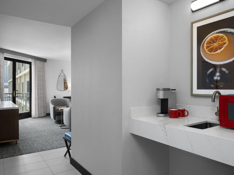 A kitchenette in the Latitude Suite with a coffee maker, microwave, and sink at Hotel 43 Boise