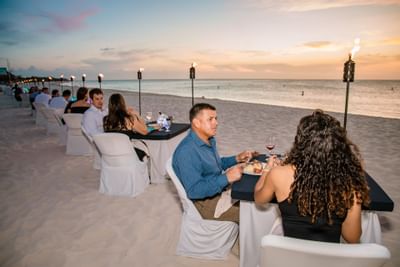 Couples having dinner by the beach at Amsterdam Manor Resort