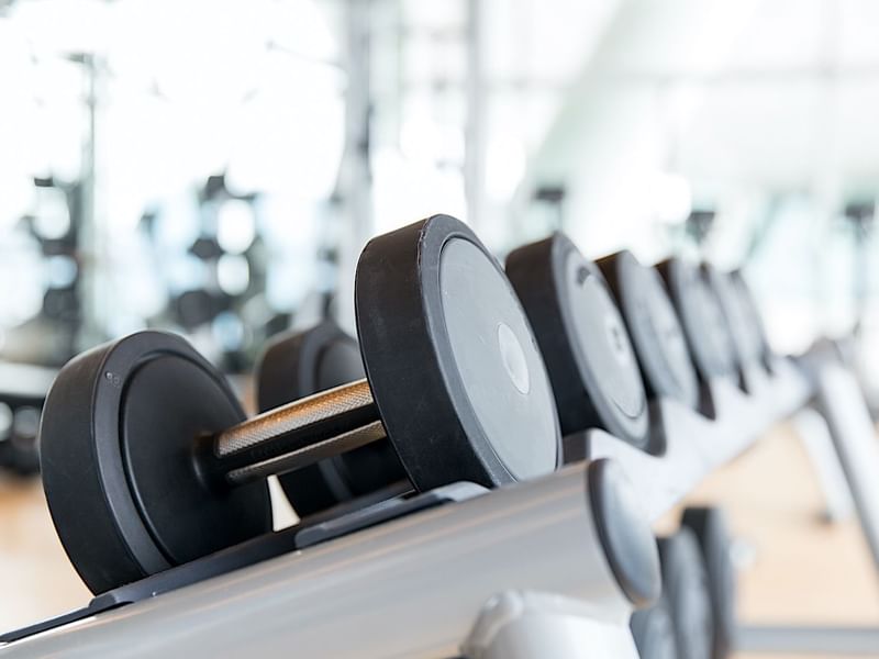 A rack of various dumbbells in the well-equipped fitness center at El Prado Hotel