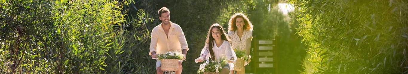 A family of three cycling in the pathway near Titanic Hotels