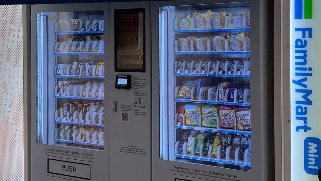 Two vending machines with blue awning and Family Mart Mini sign on the side.