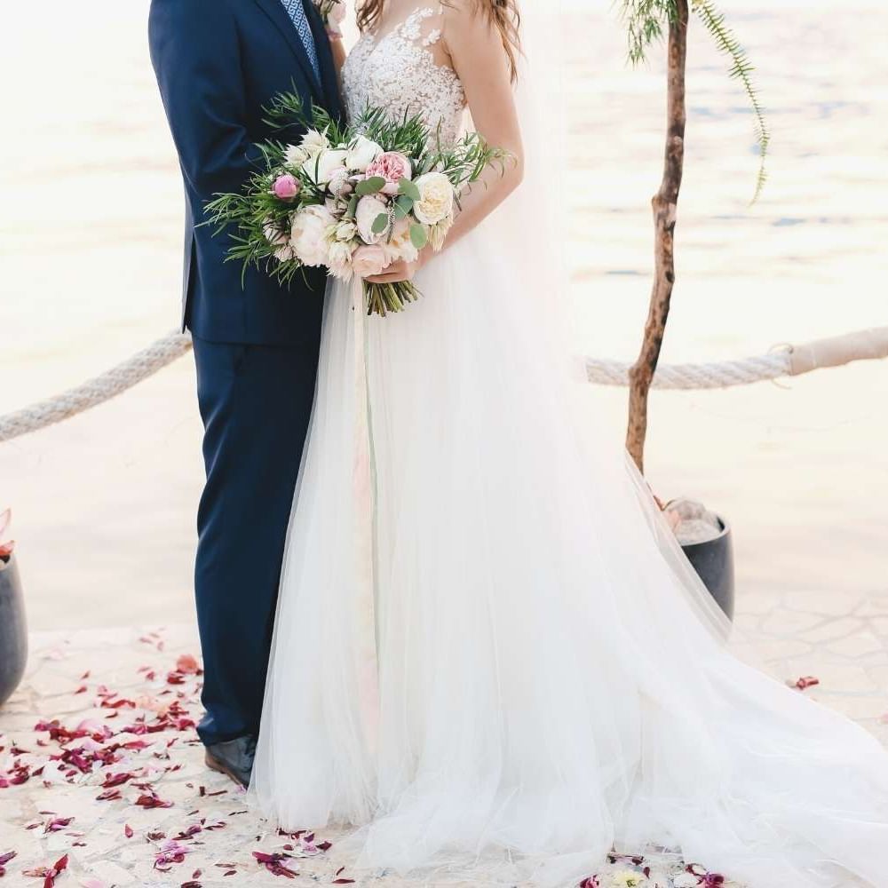 Newly wedded couple posing by the ceremony on the Beach near Waikiki Resort Hotel by Sono