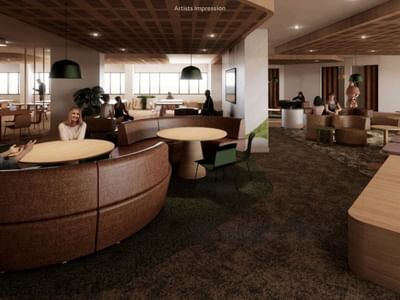 Modern lobby area with round tables and circular seating at UniLodge Brisbane City.
