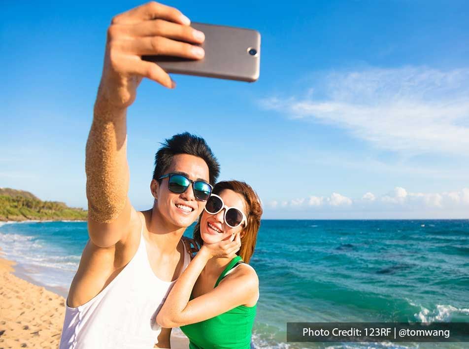 Couple Takes Photo At The Beach