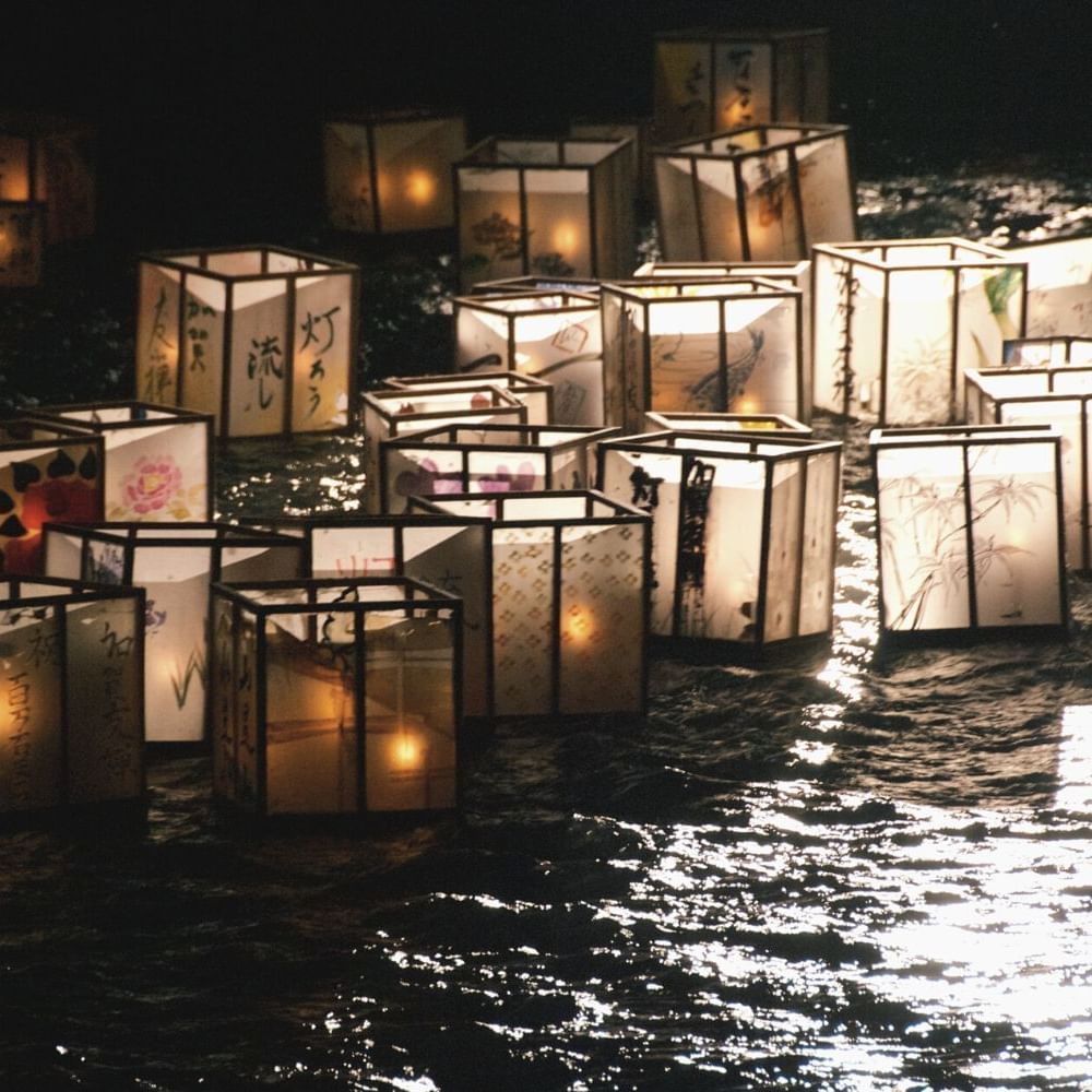 Lanterns floating the water at night near Waikiki Resort Hotel by Sono