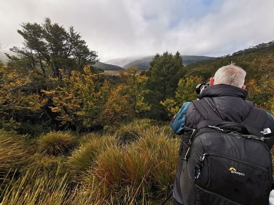 A photographer taking pictures near Cradle Mountain Hotel