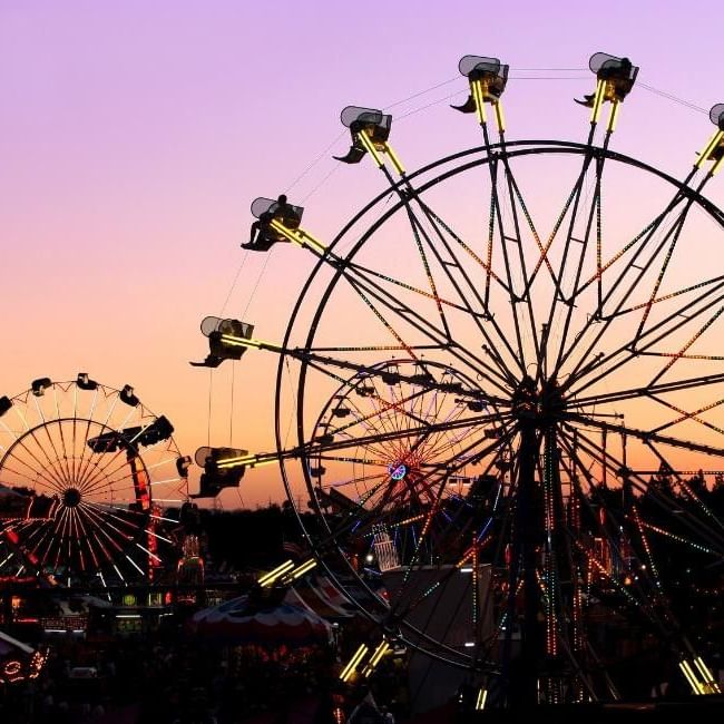 Sunset view of carnival rides and attractions at Crowthorne Carnival Fun For All.