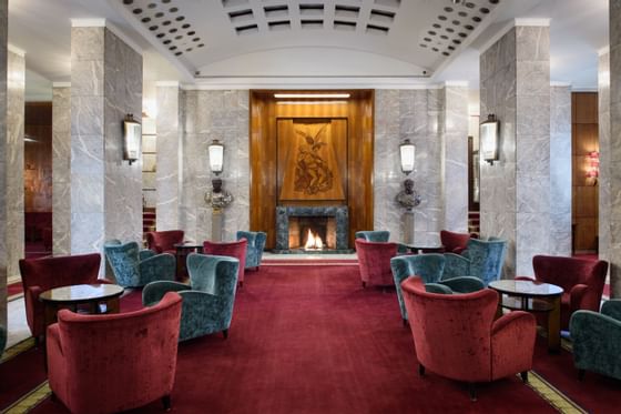 Hotel lounge with red chairs & red carpets at Bettoja Hotel Mediterraneo