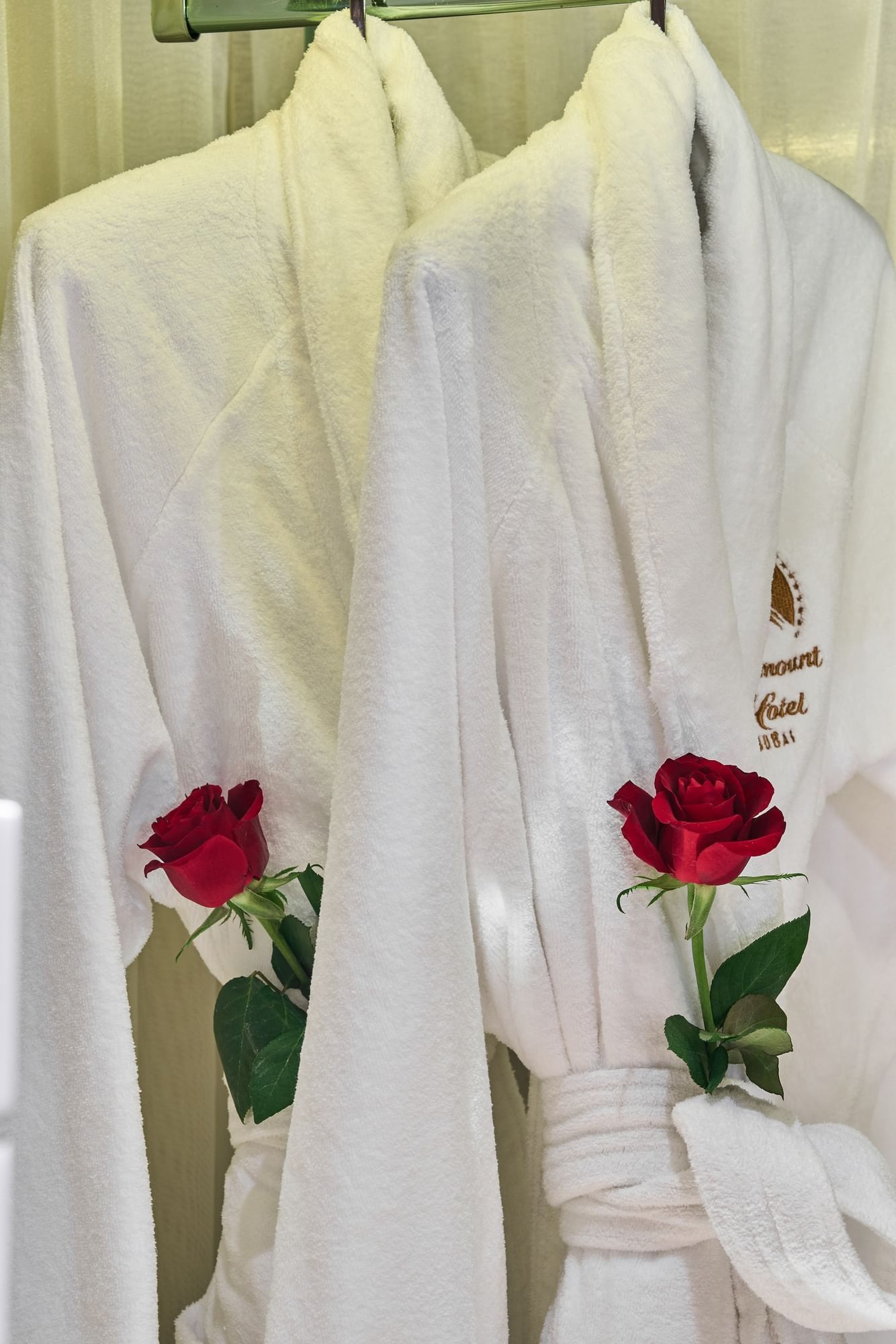 Close-up of white robes with red roses at Paramount Hotel Dubai