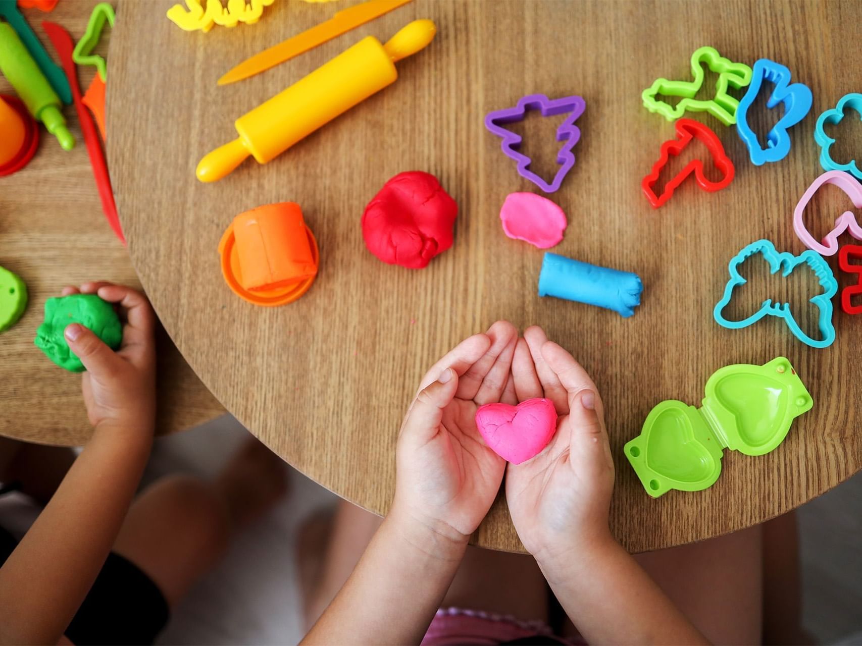 Children making shapes from playdough in Kids Club at Golf Hotel Punta Ala