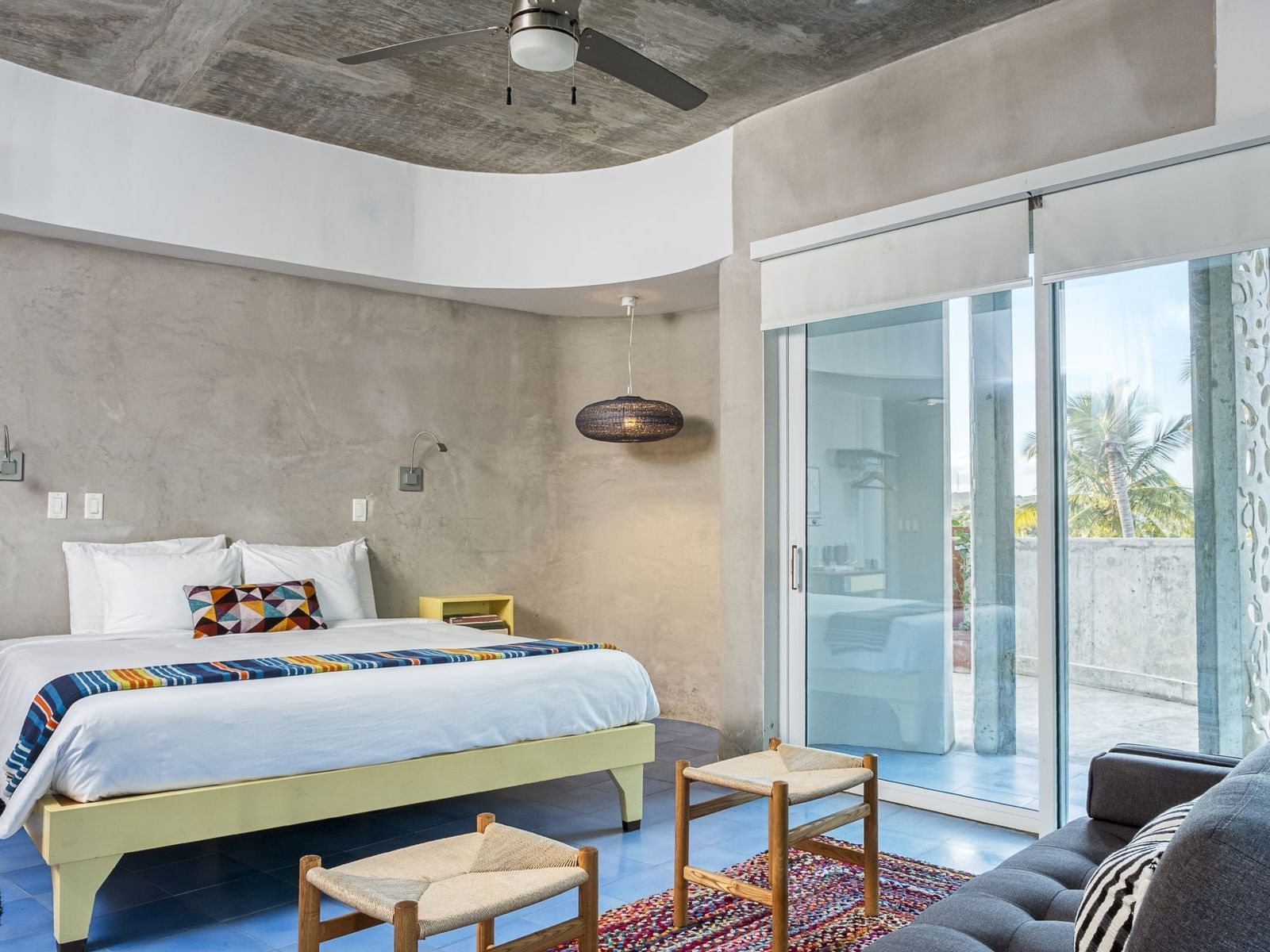 Modern room with bed and couch at El Blok Vieques.
