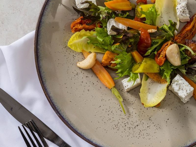 Close-up of salad dish with fork & knife at Pullman Port Douglas
