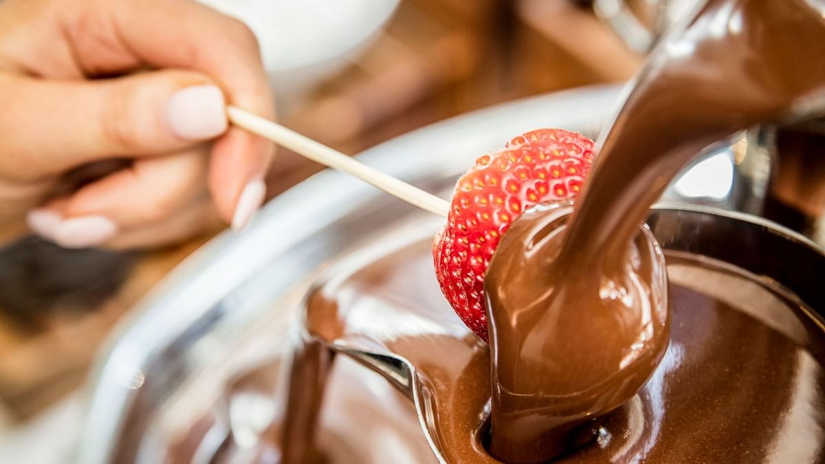 Strawberry being dipped into chocolate in Mesh restaurant at Crown Hotel Melbourne