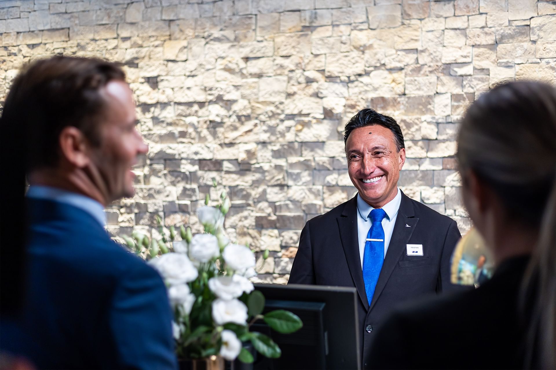 Couple checking in by the reception at Novotel Darling Square