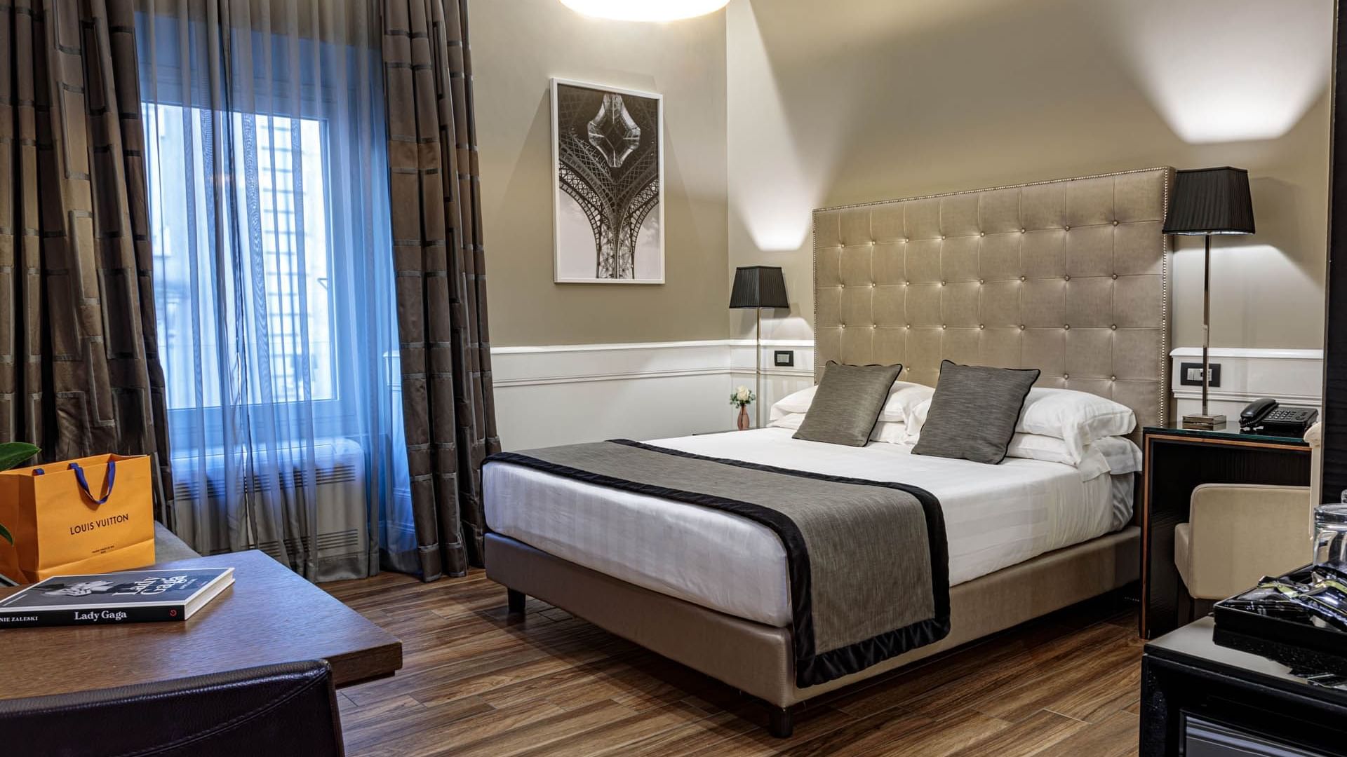 Modern Classic Room with a king bed, chic decor, desk, curtained windows, and elegant lighting at The Independent Suites
