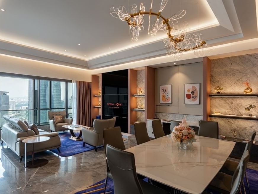 Living room area and dining table in Imperial Pool Suite at Imperial Lexis Kuala Lumpur