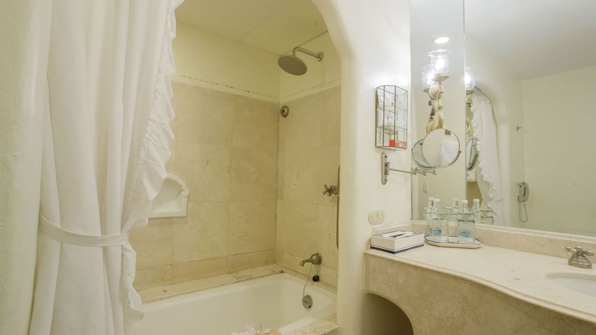 2 Double Master Suite marble bathroom showing a rainfall shower and elegant vanity lighting at Quinta Real Acapulco