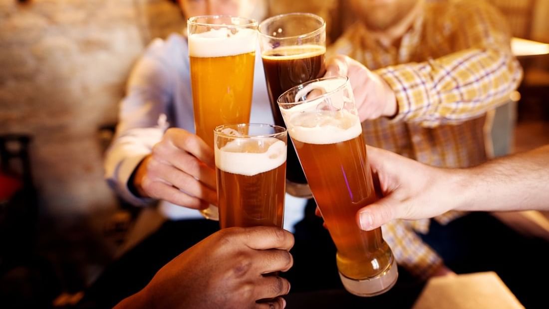 Four friends toasting beers in Frankie Farrell's Pub and Grill at Lake Buena Vista Resort Village & Spa