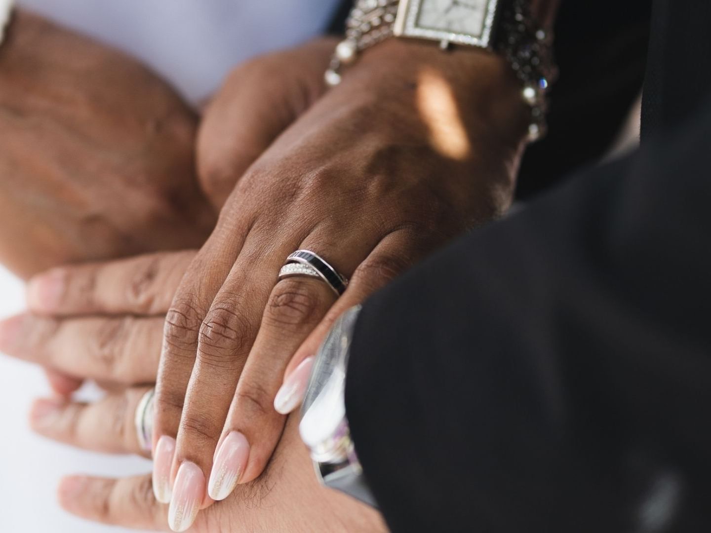 Hands of a couple wearing wedding rings at Savannah Beach Hotel.