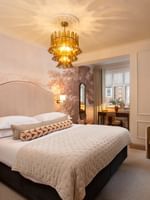 Elegant one bedroom apartment interior at The Capital Hotel in London with king bed and modern decor