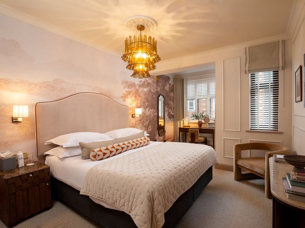 Bed with side tables near vanity table in One Bedroom Apartment at The Capital Hotel, Apartments and Townhouse