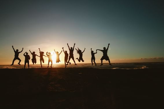 A group of people jumping together at The View Eastbourne