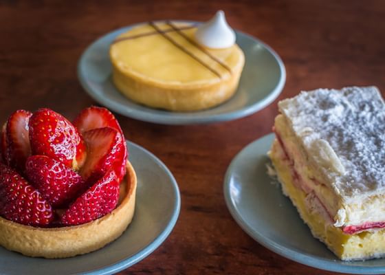 Close-up of desserts served on a table in a restaurant at Strahan Village