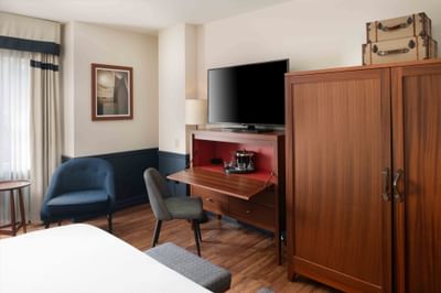 TV & workspace facing the bed in Deluxe Rooms at Portland Harbor Hotel