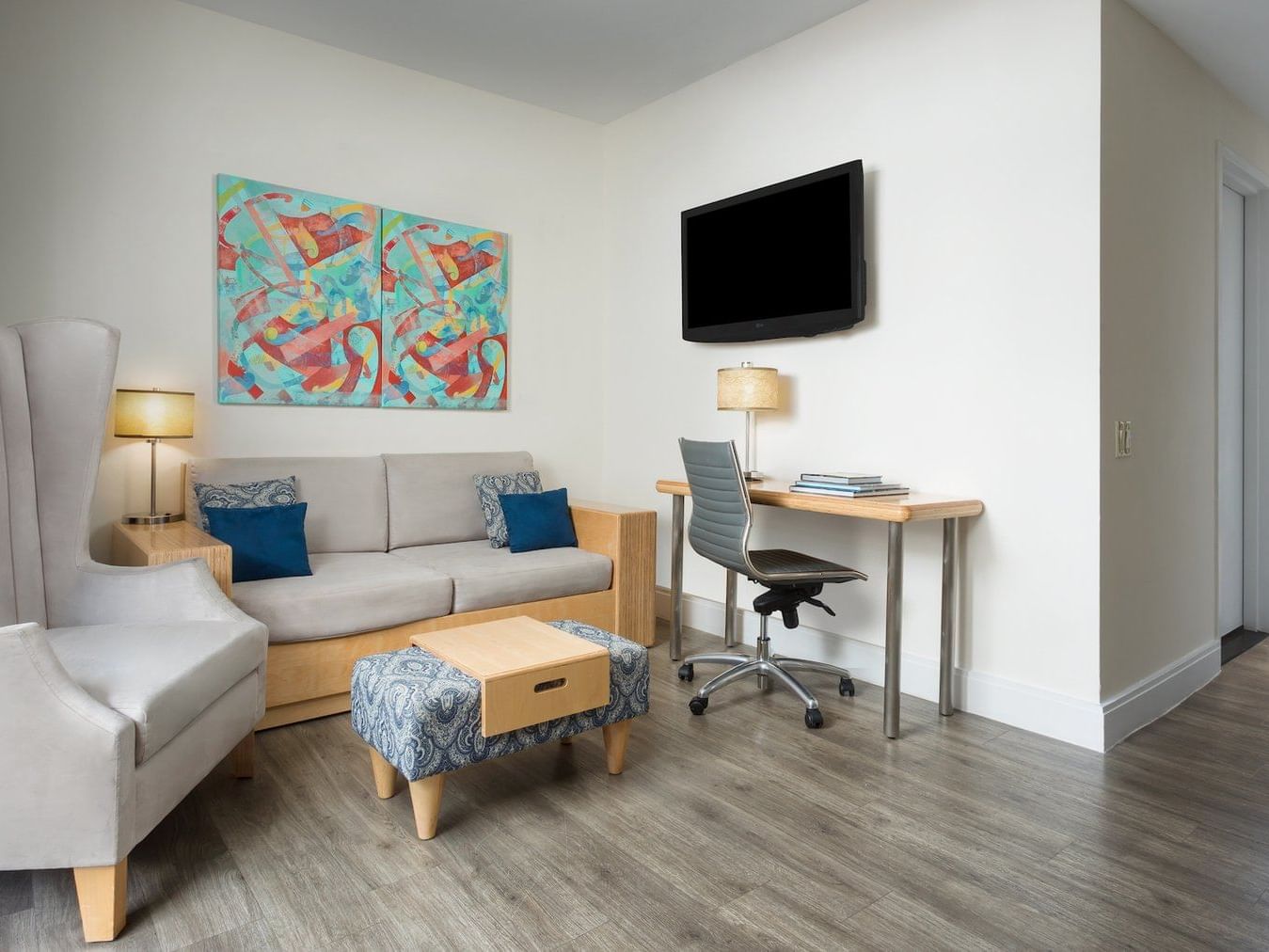 a desk and couch in a hotel room
