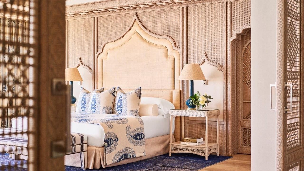Villa del Mar bedroom with arched fabric headboard and detailed woven wall at Marbella Club