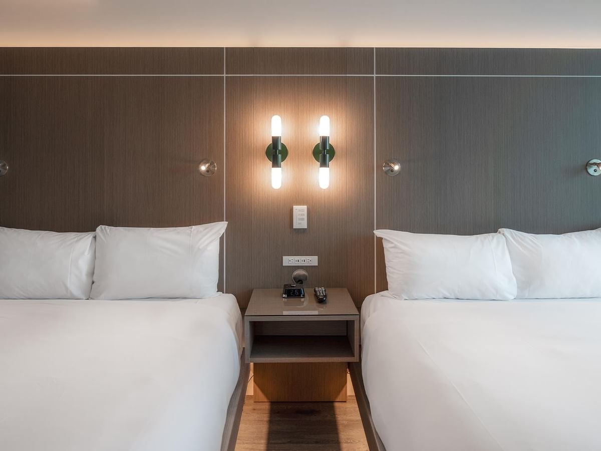 Two queen beds with white bedding.