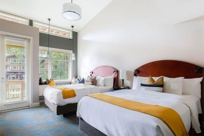 Two comfy beds and outside view in Courtyard Double Queen at Alderbrook Resort & Spa