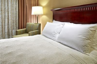 Bed with couch in 2 Bedroom Superior Suite at Anaheim Portofino Inn, a Disneyland good neighbor hotel with kids suites