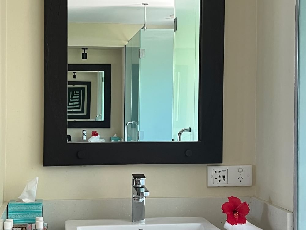 Bathroom sink and mirror in the Beach Front Bure with Plunge Pool at Tambua Sands Beach Resort Sigatoka.