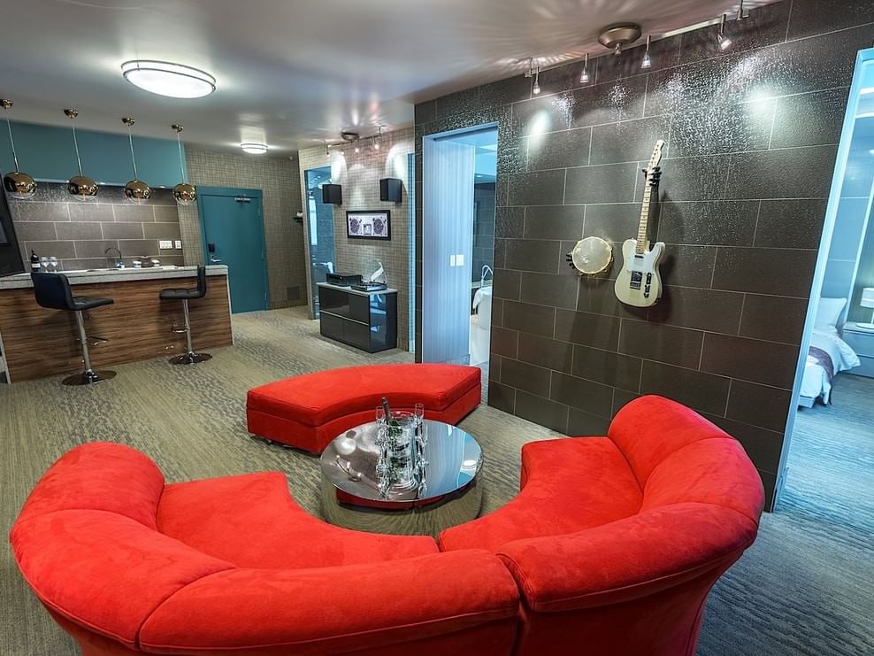 Living area with couch and counter in Vinyl Themed Suite at Hotel Clique Calgary Airport