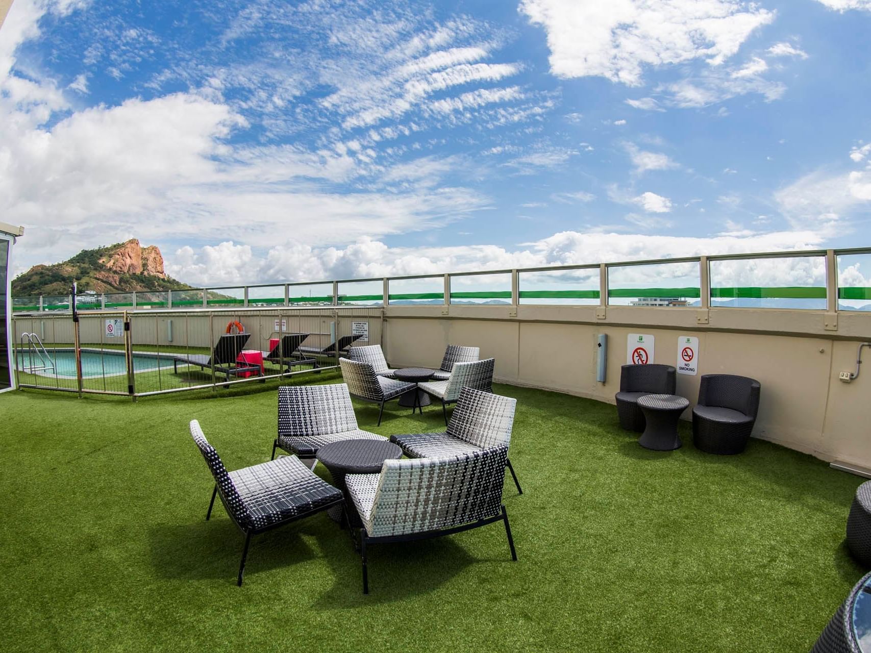 Rooftop lounge area by the swimming pool at Grand Chancellor Townsville