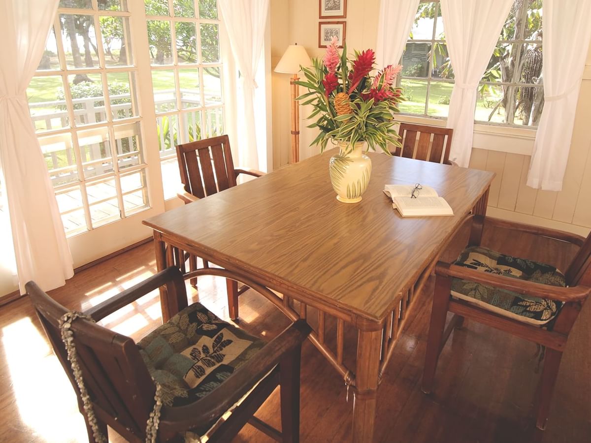 Dining room with table, chairs, and a vase